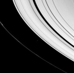 A small icy world plies between Saturn